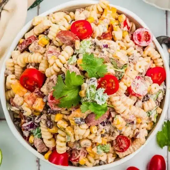 Colorful Cowboy Pasta Salad with fresh vegetables and dressing