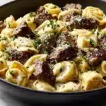 Plate of Cracked Garlic Steak Tortellini garnished with herbs