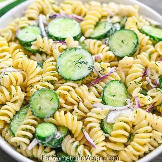 Creamy Cucumber Pasta Salad served in a bowl with fresh cucumbers and herbs