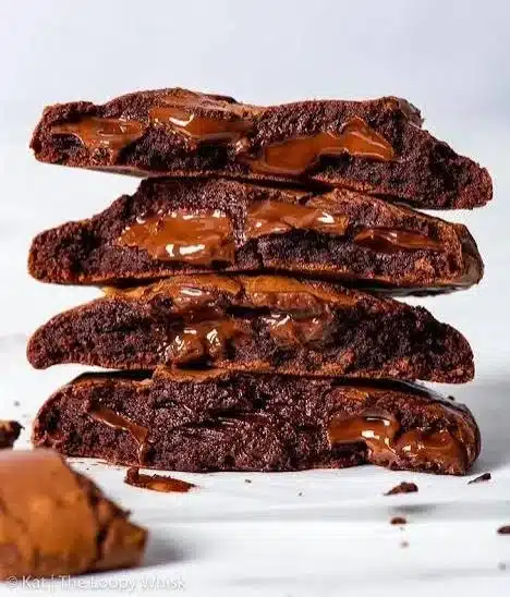 Fudgy chocolate cookies stacked on a plate, showcasing their rich texture.