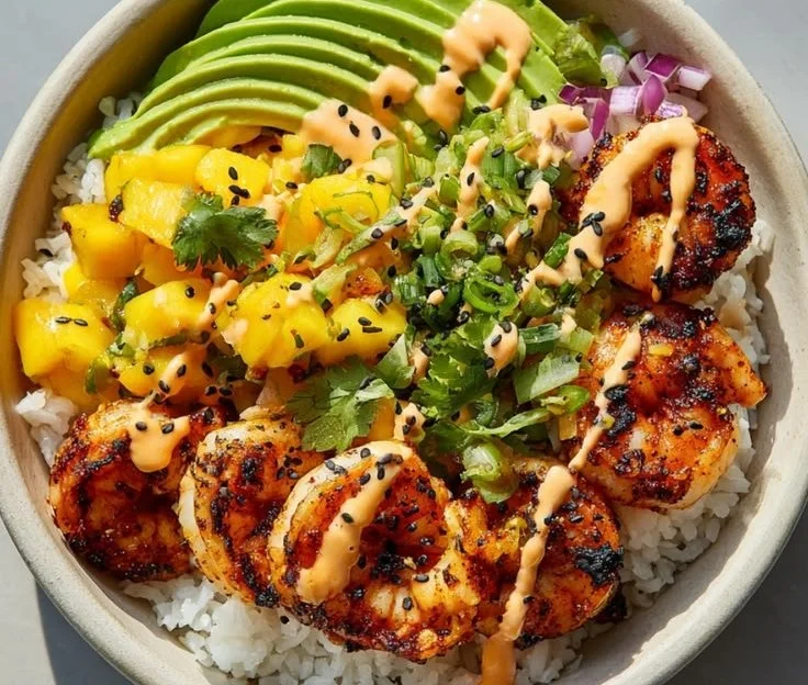 Healthy grilled shrimp and avocado bowl served in a vibrant dish