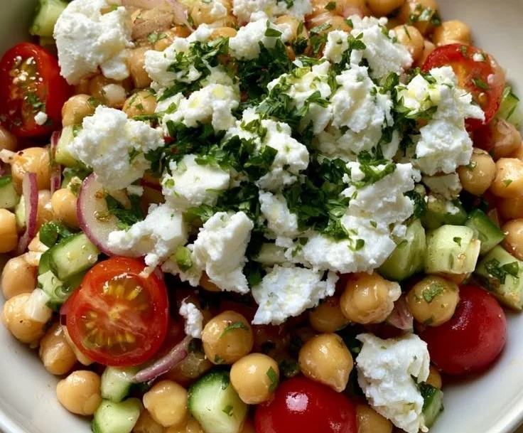 High-protein chickpea and cucumber salad in a bowl, garnished with herbs