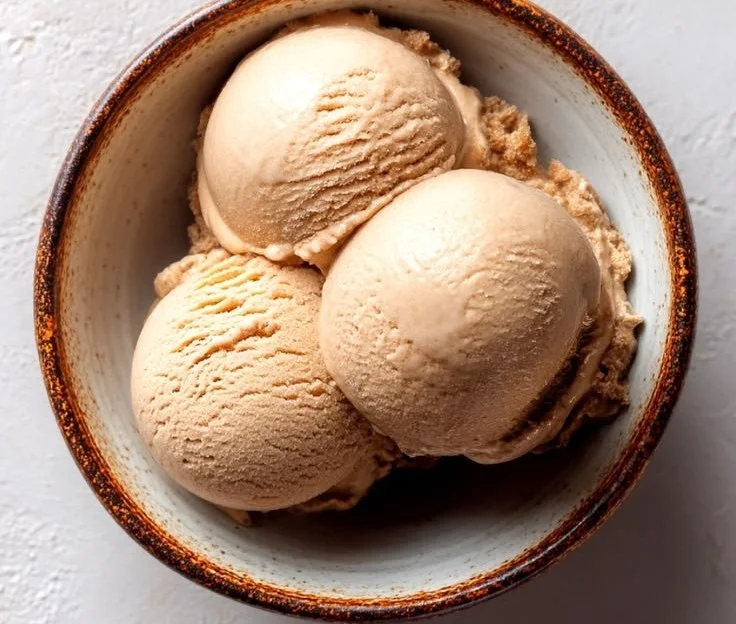 Delicious Italian coffee ice cream in a bowl, topped with coffee beans.