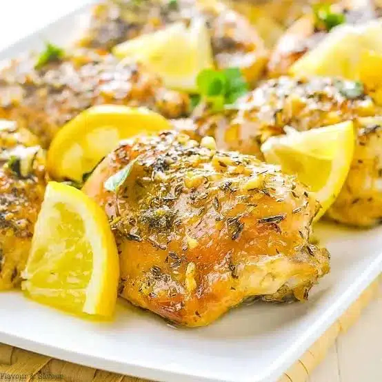 Delicious lemon chicken served with herbs and a slice of lemon
