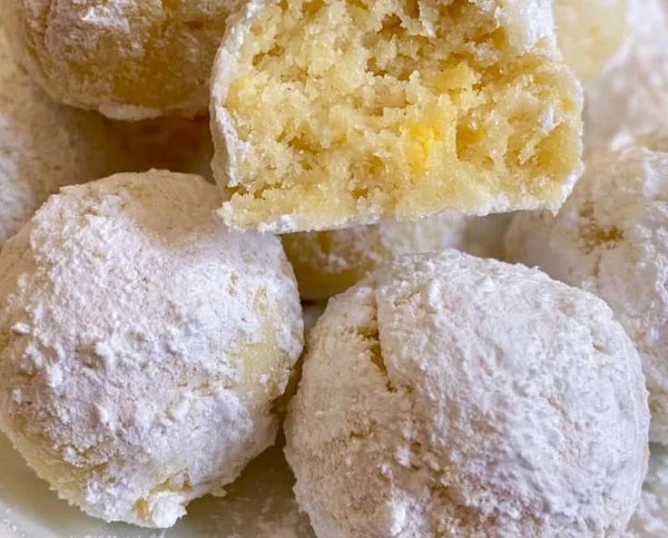 Plate of delicious Lemon Snowball Cookies dusted with powdered sugar