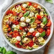 Colorful Mediterranean Tortellini salad with fresh vegetables and herbs
