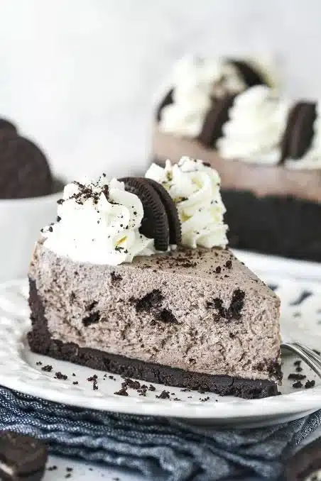 No Bake Oreo Cheesecake with crushed Oreos and creamy filling on a dessert plate