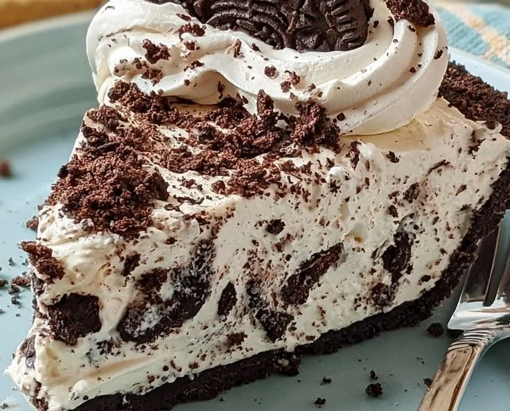 Delicious Oreo Cream Pie topped with whipped cream and crushed Oreos