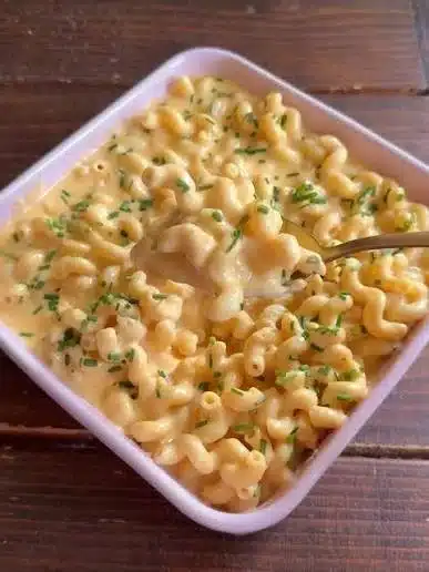 Creamy Protein Mac and Cheese with a cheesy topping and side ingredients