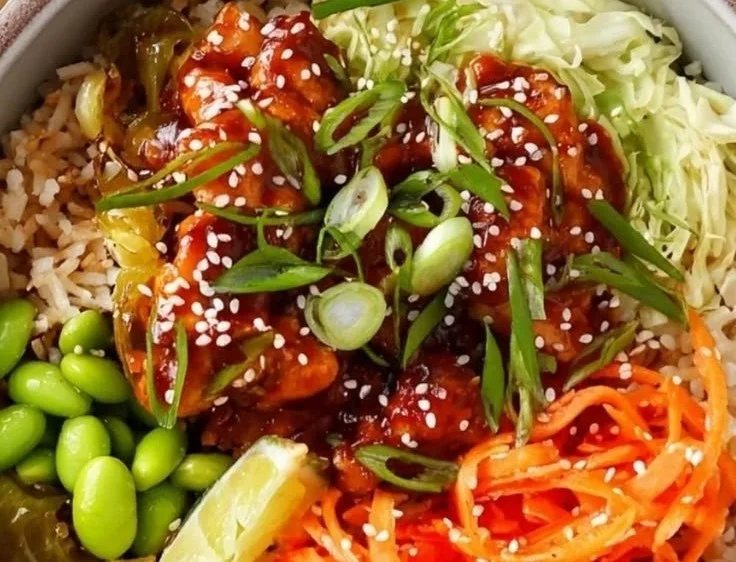 Delicious Sweet Chili Chicken Rice Bowl garnished with fresh vegetables
