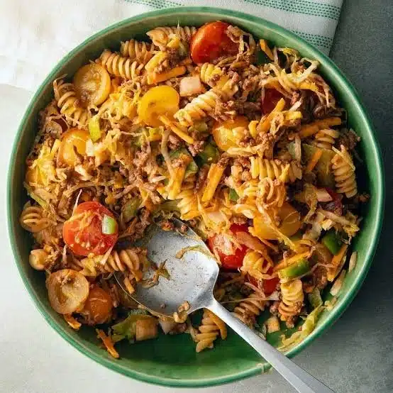 Colorful Taco Pasta Salad with fresh ingredients and toppings in a bowl