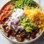 Delicious Taco Rice Bowl topped with fresh ingredients and served in a vibrant bowl