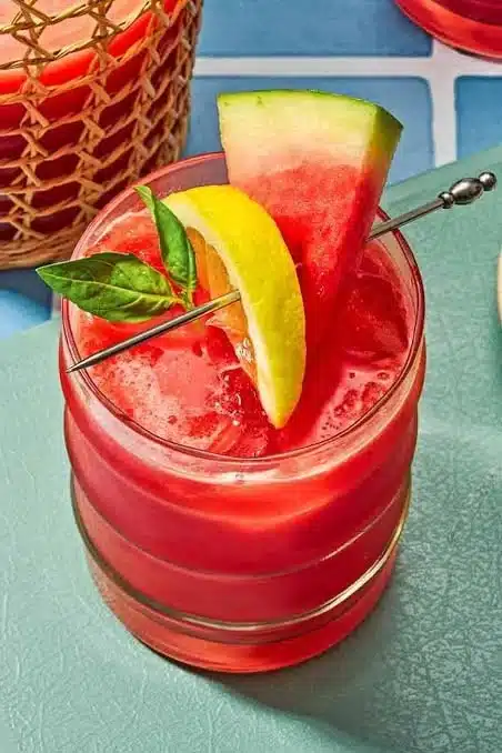 Glass of refreshing watermelon lemonade with mint garnish