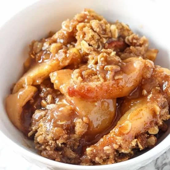 Delicious homemade Apple Crisp served warm with ice cream on top