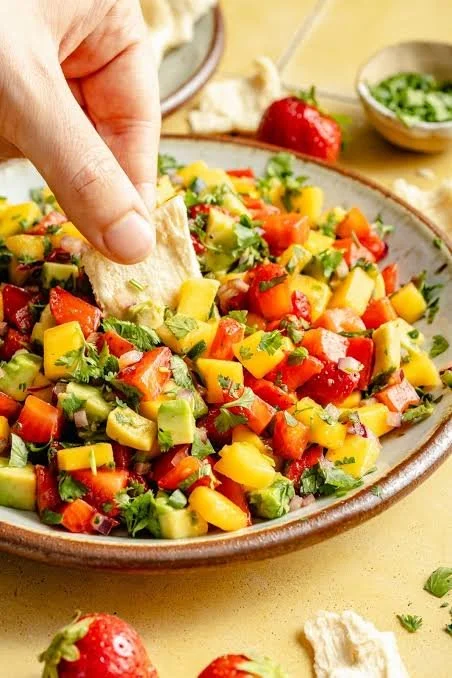 Bowl of colorful Avocado Strawberry Mango Salsa with fresh ingredients