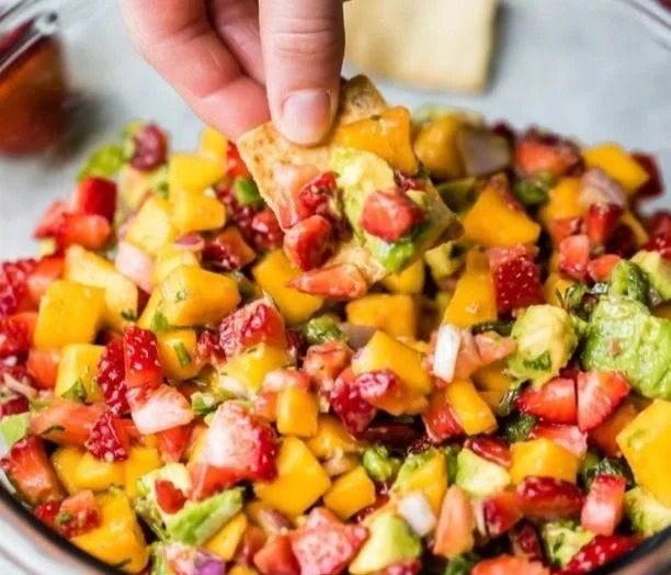 Fresh avocado strawberry mango salsa served in a colorful bowl