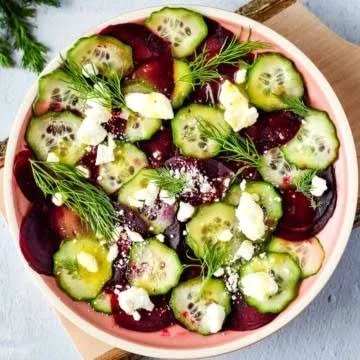 Vibrant beet salad with feta cheese and fresh cucumbers in a bowl