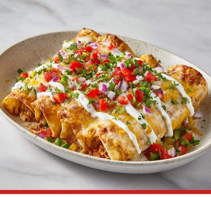 Tasty Chicken Enchiladas served with cheese and toppings.
