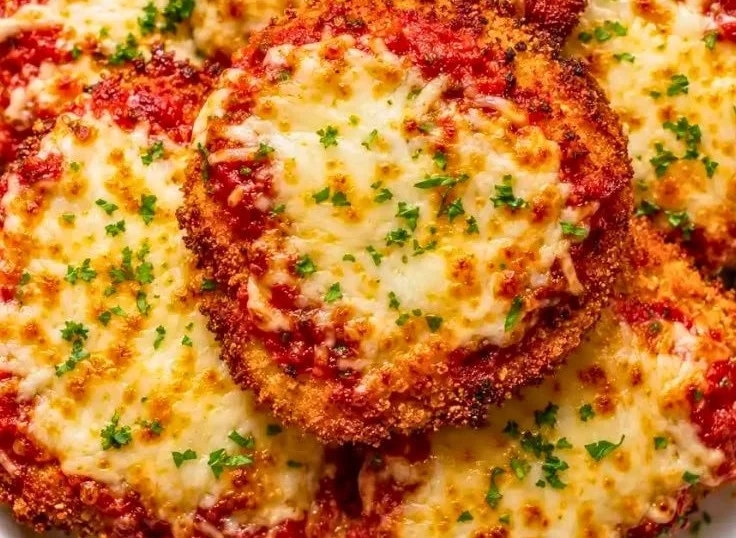 Crispy Ground Chicken Parmesan served with marinara sauce and fresh basil.