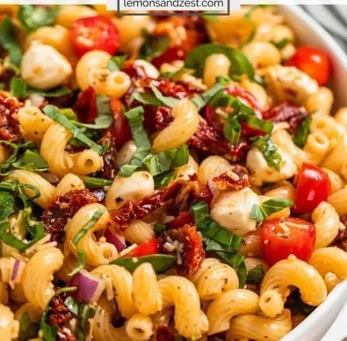 Delicious bowl of Dried Tomato Pasta Salad with vibrant veggies and herbs