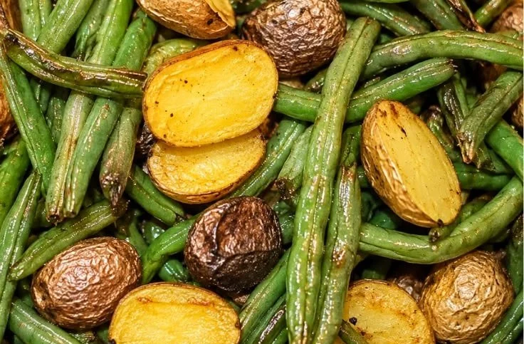 Crispy air fryer potatoes and green beans on a plate