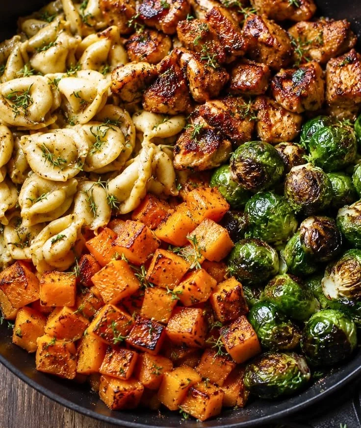 Bowl of Easy Autumn Chicken Tortellini garnished with herbs and vegetables