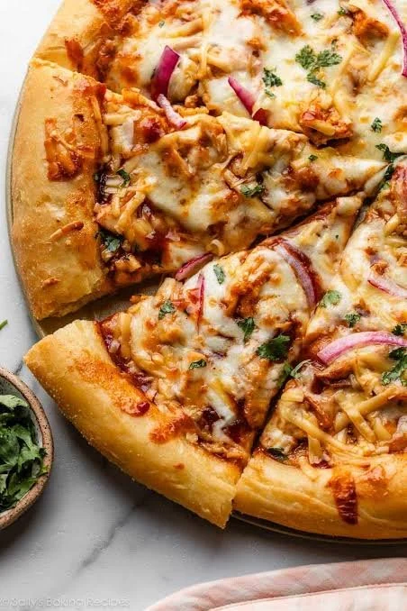 Homemade easy BBQ chicken pizza topped with cheese and fresh ingredients