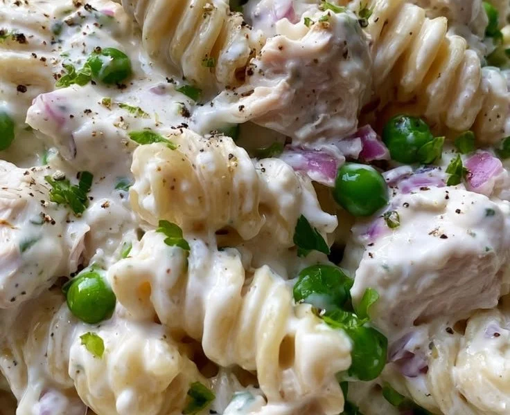 Delicious Easy Creamy Chicken Pasta Salad garnished with fresh herbs