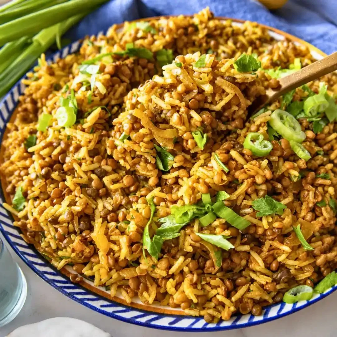 A healthy bowl of Mediterranean lentils and rice with fresh herbs and spices.