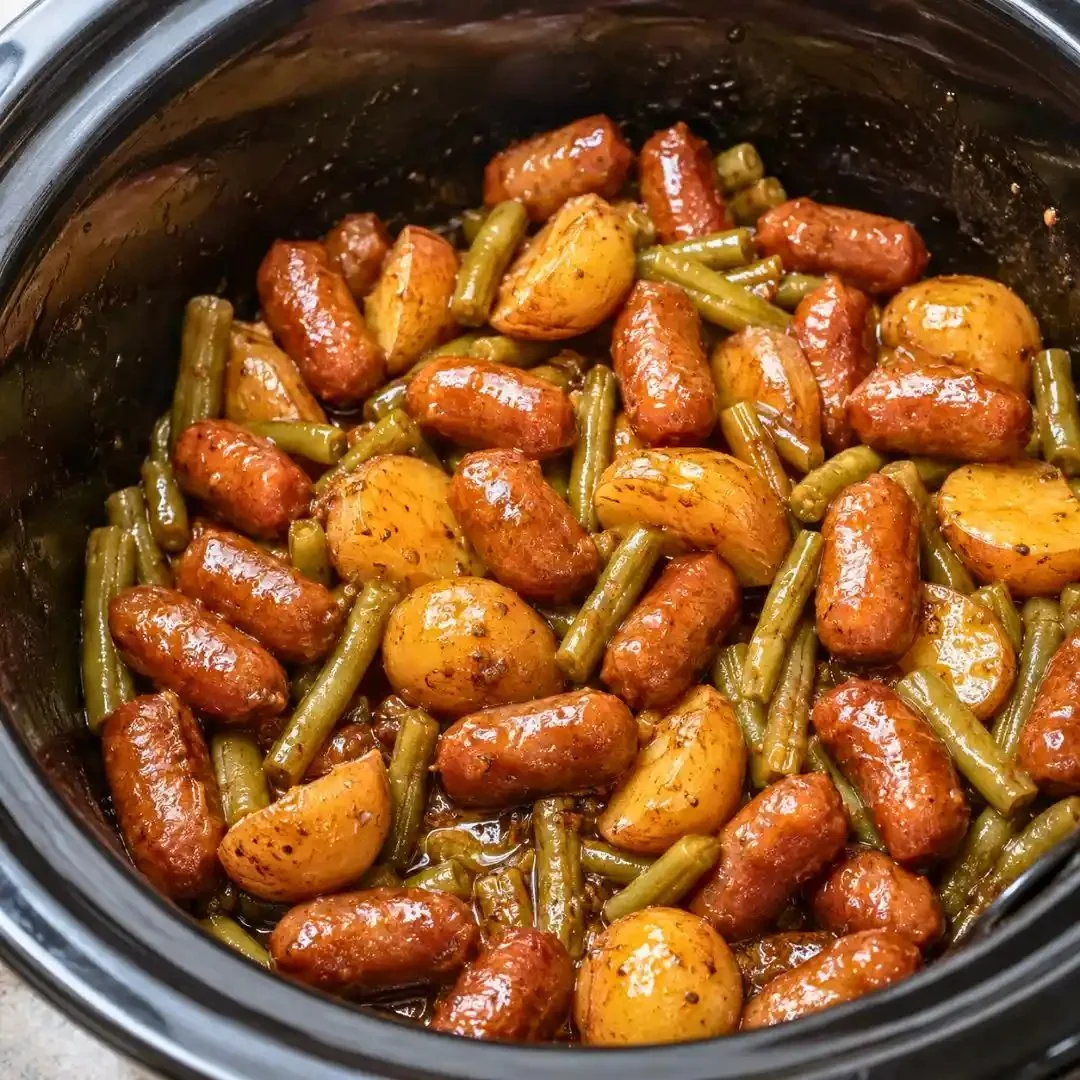 Crockpot beef sausages with potatoes and green beans cooked together.