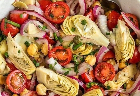 Vegan Tuscan Salad with artichokes and tomatoes in a bowl