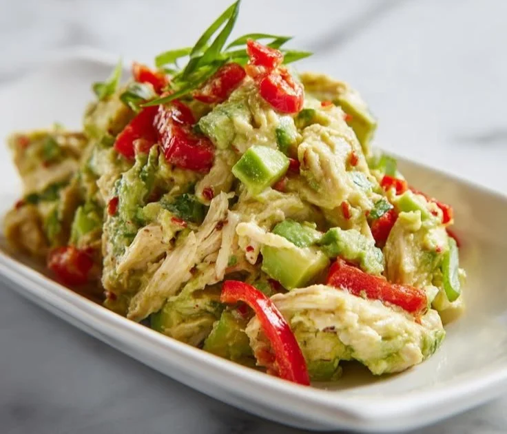 Healthy avocado chicken salad with fresh ingredients in a bowl