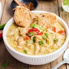 Bowl of healthy high protein white chicken chili topped with cilantro