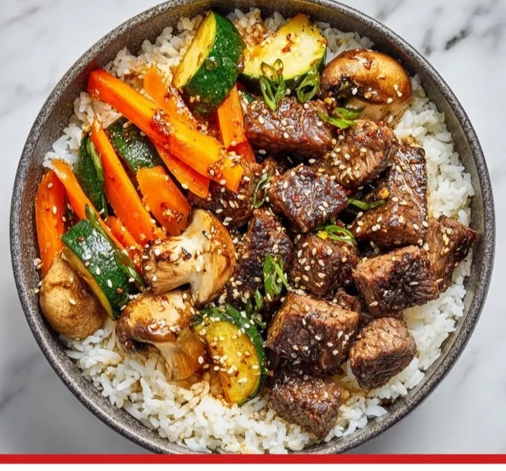 Delicious Hibachi Steak Bowl topped with fresh vegetables and sauces