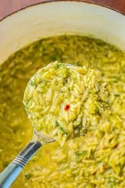 Bowl of Italian broccoli soup garnished with herbs and cheese