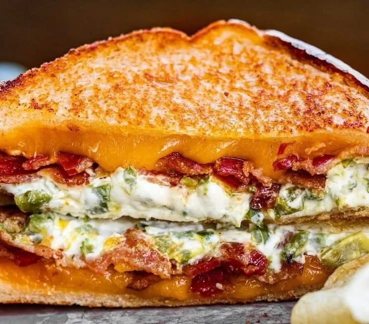 Melted jalapeño popper grilled cheese sandwich on a plate