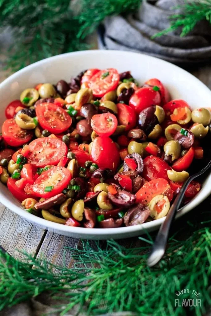 Delicious marinated tomato olive salad served in a bowl