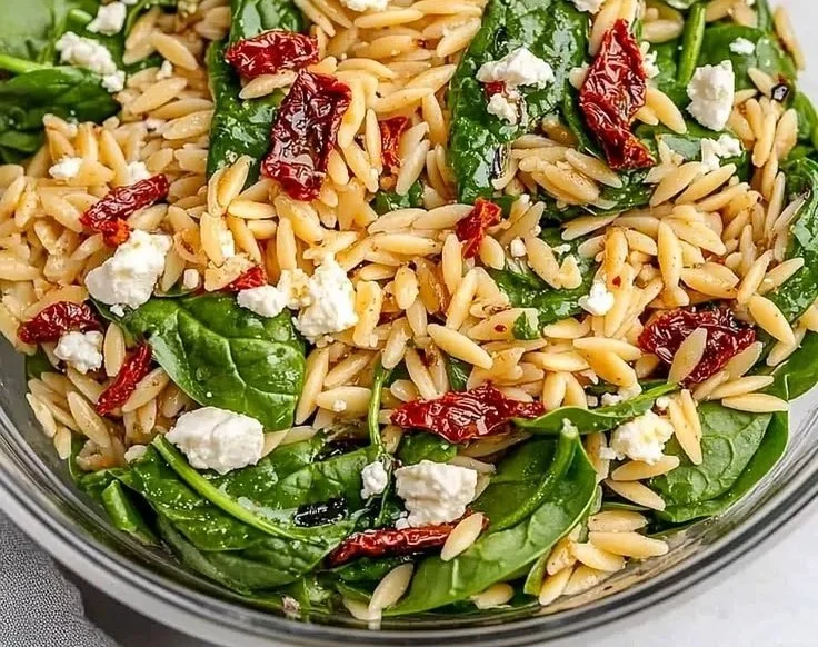 Nutritious balsamic orzo salad with fresh vegetables and dressing