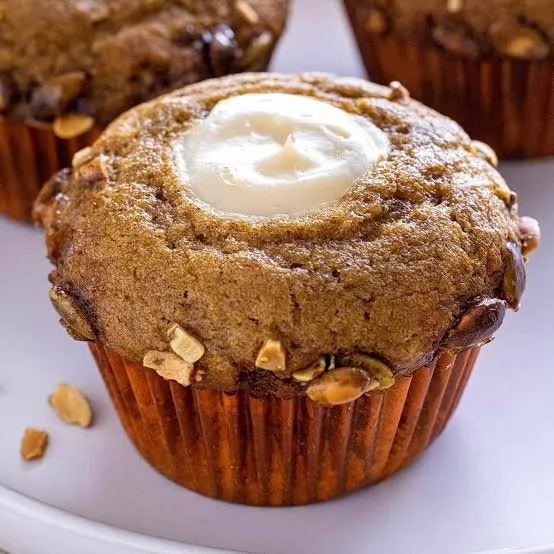 Delicious Pumpkin Cream Cheese Muffins topped with cream cheese frosting