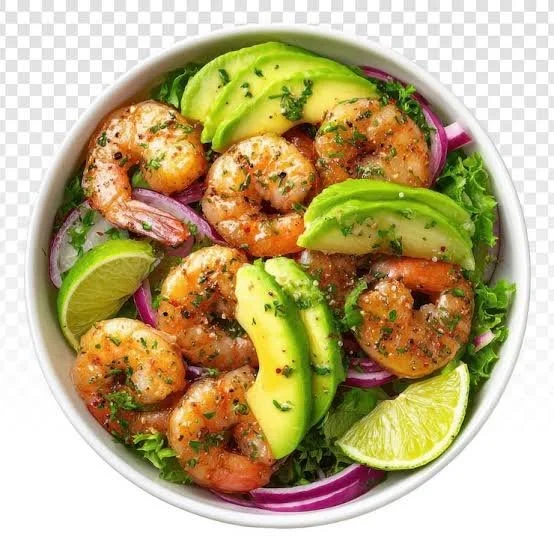 Zesty lime shrimp and avocado salad served in a bowl with fresh ingredients.