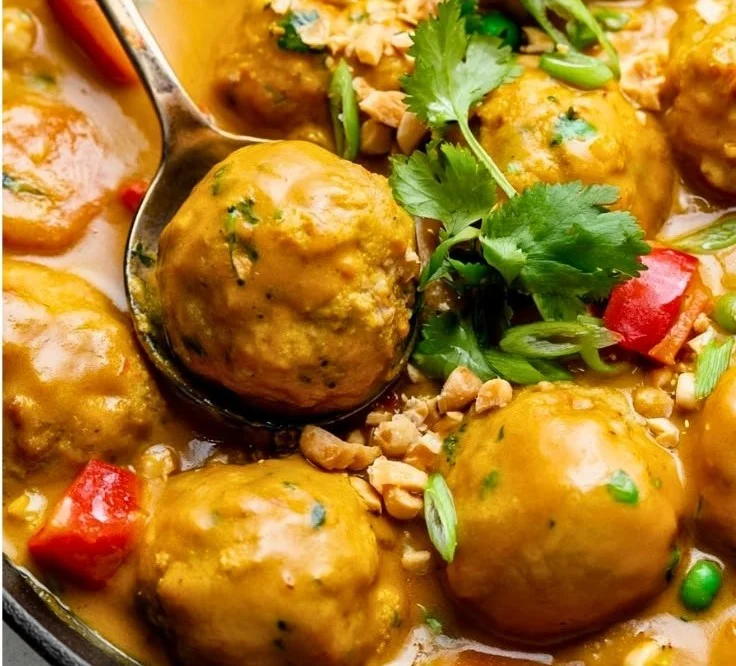 Chicken meatballs in pumpkin coconut curry sauce served in a bowl