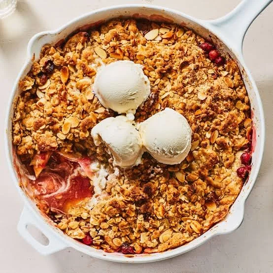 Cranberry Apple Crumble topped with oats in a baking dish