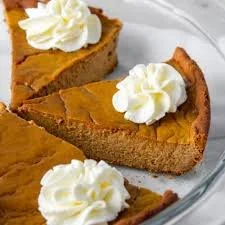 Delicious crustless pumpkin pie served on a plate with whipped cream