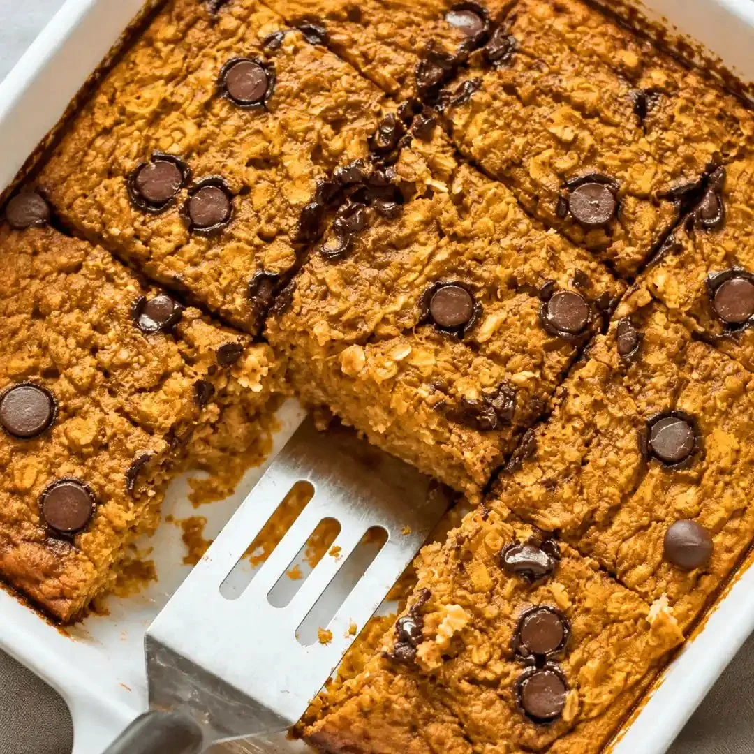 Delicious pumpkin baked oatmeal served in a bowl, garnished with nuts and spices.
