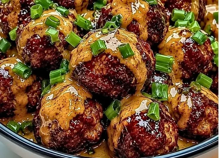 Delicious sticky hoisin meatballs garnished with scallion sauce.