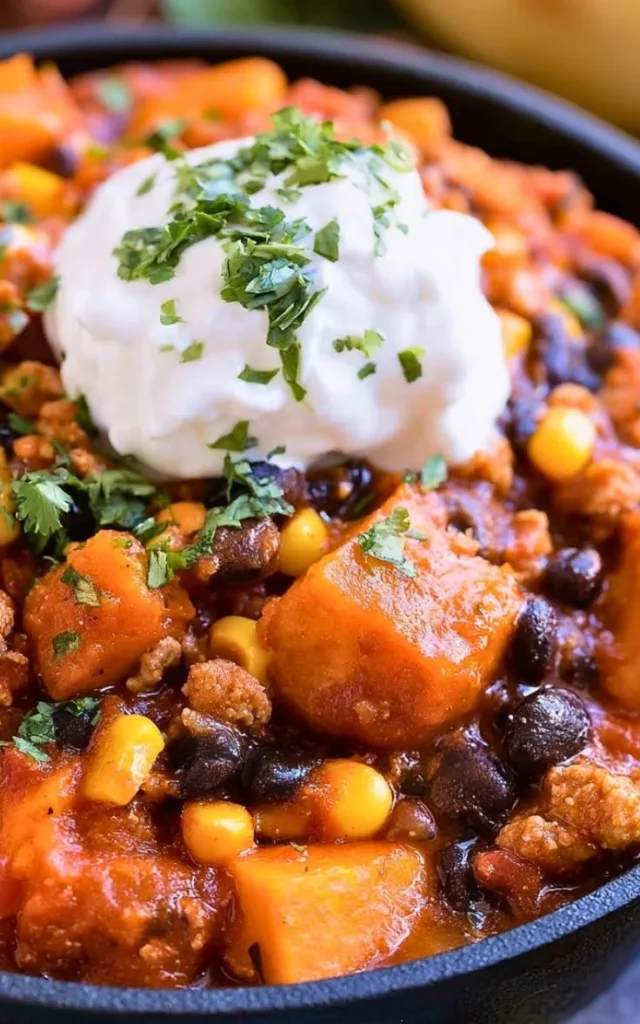 Bowl of easy turkey sweet potato chili garnished with cilantro and avocado