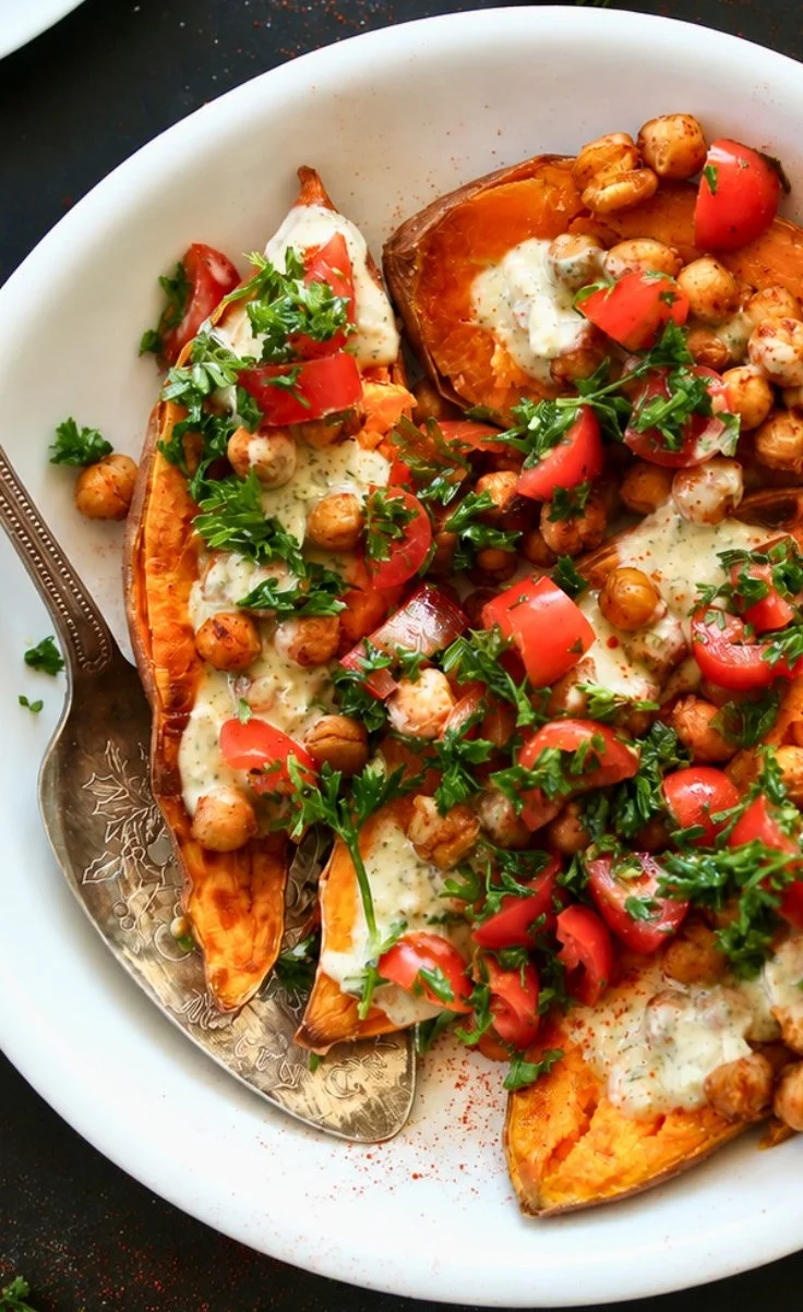 Mediterranean baked sweet potatoes garnished with herbs and spices.