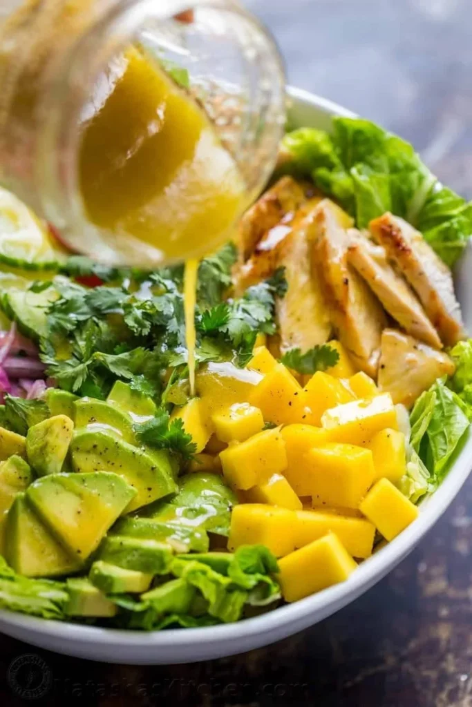 Homemade Honey Vinaigrette Dressing in a glass jar with fresh ingredients.