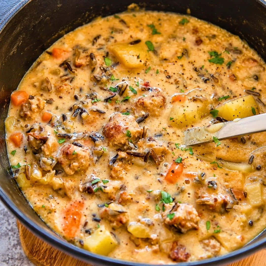 Bowl of hearty Potato and Sausage Chowder topped with fresh herbs