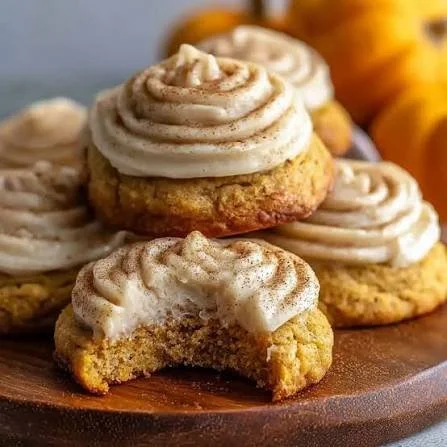 Delicious pumpkin cookies with cream cheese frosting on a plate